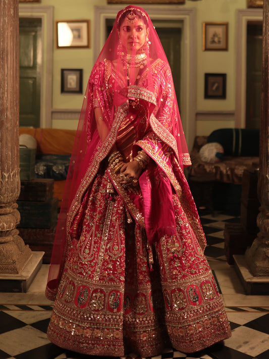 Designer Rani Color Raw Silk Lehenga Choli with Traditional Detailing for Brides and Special Events